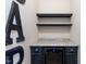 Charming bar area features black cabinets, granite countertops, and a sleek wine cooler at 2082 Weston Green Loop Loop, Cary, NC 27513