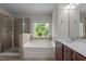 Elegant bathroom featuring separate shower, garden tub and double vanity at 2082 Weston Green Loop Loop, Cary, NC 27513