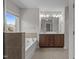 Bright and spacious bathroom features a large soaking tub, dual sinks, and natural light at 2082 Weston Green Loop Loop, Cary, NC 27513