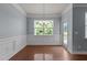 Well-lit dining room with chair rail, chandelier, and access to outdoor patio at 2082 Weston Green Loop Loop, Cary, NC 27513