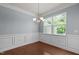 Dining area featuring wainscoting, chandelier, and a large window offering natural light at 2082 Weston Green Loop Loop, Cary, NC 27513