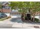 Charming townhouse featuring a two-car garage, manicured landscaping, and a well-maintained driveway at 2082 Weston Green Loop Loop, Cary, NC 27513