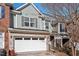 Charming townhome with a two-car garage, brick accents, and light blue siding at 2082 Weston Green Loop Loop, Cary, NC 27513