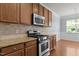 Gourmet kitchen featuring granite countertops, stainless steel range and oven at 2082 Weston Green Loop Loop, Cary, NC 27513