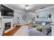 Cozy living room featuring a fireplace, modern furnishings, and neutral tones at 2082 Weston Green Loop Loop, Cary, NC 27513