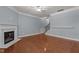 Spacious living area featuring a fireplace, hardwood floors, and a staircase at 2082 Weston Green Loop Loop, Cary, NC 27513