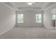Spacious main bedroom with trey ceiling, two windows and neutral carpeting at 2082 Weston Green Loop Loop, Cary, NC 27513