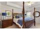 Elegant main bedroom featuring a four-poster bed, ample lighting, and calm decor at 2082 Weston Green Loop Loop, Cary, NC 27513