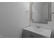 Stylish powder room with elegant vanity and decorative mirror at 2082 Weston Green Loop Loop, Cary, NC 27513