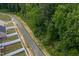 Scenic aerial view of a peaceful neighborhood street lined with lush green trees at 228 Shingle Oak Rd, Wake Forest, NC 27587