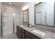Well-lit bathroom with granite countertops, a glass-enclosed shower, and modern fixtures at 228 Shingle Oak Rd, Wake Forest, NC 27587