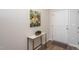 Bright foyer features a marble-topped console table, floral art, and an inviting entrance with wood-look floors at 228 Shingle Oak Rd, Wake Forest, NC 27587