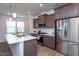 A modern kitchen boasts a center island with a quartz countertop, stainless steel appliances, and ample storage at 228 Shingle Oak Rd, Wake Forest, NC 27587