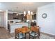 The open-concept kitchen features a quartz countertop island, stylish lighting, and flows into the adjacent dining area at 228 Shingle Oak Rd, Wake Forest, NC 27587