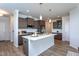 Spacious kitchen features a center island with quartz countertops and dark wood cabinets and stainless appliances at 228 Shingle Oak Rd, Wake Forest, NC 27587