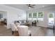 Bright living room with large windows, comfortable seating, and a view of the outdoors at 228 Shingle Oak Rd, Wake Forest, NC 27587
