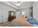 Bedroom features a tray ceiling, wood floors, and furniture with an open doorway to ensuite bath at 24 W Catalina Ct, Clayton, NC 27527