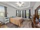 Bright bedroom with tray ceiling, wood floors, large windows and neutral colors for a serene retreat at 24 W Catalina Ct, Clayton, NC 27527