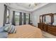 Bedroom features a tray ceiling, wood floors, large windows and traditional furnishings at 24 W Catalina Ct, Clayton, NC 27527