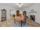 Bright dining area with colorful table setting, fireplace, and view of multiple living spaces at 24 W Catalina Ct, Clayton, NC 27527