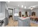 Spacious kitchen with center island, flowing into dining area with fireplace and lots of natural light at 24 W Catalina Ct, Clayton, NC 27527