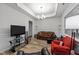 Spacious living room featuring a coffered ceiling, large windows and classic decor for cozy relaxation at 24 W Catalina Ct, Clayton, NC 27527