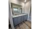 Bathroom with double sink vanity, granite counters, modern fixtures, and wood look floors at 240 Eason Creek Way, Clayton, NC 27527