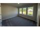 Well-lit bedroom with three large windows offering a pleasant outdoor view at 240 Eason Creek Way, Clayton, NC 27527