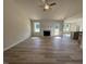 Open concept living room with hardwood floors, a fireplace, ceiling fan, and an open floorplan at 240 Eason Creek Way, Clayton, NC 27527