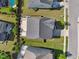 Aerial view of a meticulously landscaped backyard with a brick patio and a well maintained lawn at 241 Fishburn Dr, Apex, NC 27523