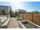 Backyard with brick patio and garden beds, perfect for enjoying outdoor relaxation and gardening at 241 Fishburn Dr, Apex, NC 27523