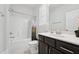The bathroom features a shower over tub and vanity with dark cabinets at 241 Fishburn Dr, Apex, NC 27523
