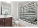 Bathroom featuring a dark-stained vanity with double sinks and a shower and tub at 241 Fishburn Dr, Apex, NC 27523