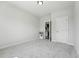 This bedroom has neutral walls, carpet and an open doorway at 241 Fishburn Dr, Apex, NC 27523