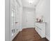 Inviting foyer featuring hardwood floors, a closet cabinet, and a bright white front door with glass panels at 241 Fishburn Dr, Apex, NC 27523