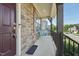 Cozy front porch with stone accents, black railings, and outdoor seating, creating a welcoming entrance at 241 Fishburn Dr, Apex, NC 27523