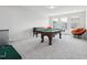 Carpeted game room with pool table, foosball, mini fridge, and sitting area at 241 Fishburn Dr, Apex, NC 27523