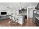 Open kitchen features granite countertops, a large island with seating, and modern dark cabinetry at 241 Fishburn Dr, Apex, NC 27523