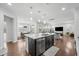Open kitchen island offers ample space for dining and entertaining with views of the living and dining areas at 241 Fishburn Dr, Apex, NC 27523
