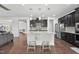 Stylish kitchen featuring a large island with barstool seating, dark cabinets, and open access to living area at 241 Fishburn Dr, Apex, NC 27523