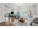 Living room is bright and airy with a modern design featuring a tray ceiling at 241 Fishburn Dr, Apex, NC 27523