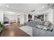 Spacious living area featuring hardwood floors, a comfortable sofa, and an open layout to the kitchen at 241 Fishburn Dr, Apex, NC 27523