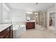 Tile main bathroom featuring a soaking tub, vanity and glass shower stall at 241 Fishburn Dr, Apex, NC 27523