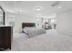 Bright main bedroom with carpet, recessed lighting, and multiple windows at 241 Fishburn Dr, Apex, NC 27523