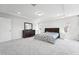 Carpeted main bedroom features tray ceilings, recessed lights, and a large dresser at 241 Fishburn Dr, Apex, NC 27523