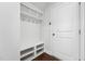 Mudroom with coat hooks and bench storage, all painted white at 241 Fishburn Dr, Apex, NC 27523