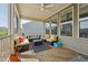 Comfortable screened-in porch with ceiling fan, rug, and plenty of seating at 241 Fishburn Dr, Apex, NC 27523
