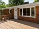 This outdoor back deck features brick home exterior and a view of the backyard at 2434 Morningside Dr, Burlington, NC 27217