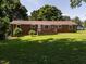 This home features a spacious backyard with mature trees and a brick exterior at 2434 Morningside Dr, Burlington, NC 27217