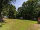 This backyard has plenty of shade and features a shed at 2434 Morningside Dr, Burlington, NC 27217